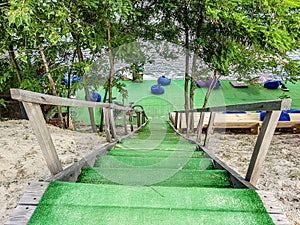 Wooden steps leading down to the beach, pond through the trees