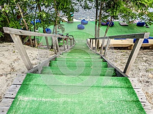 Wooden steps leading down to the beach, pond through the trees