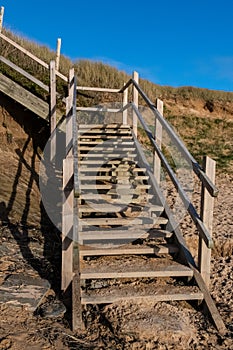 Wooden steps leading down to the sandy beach