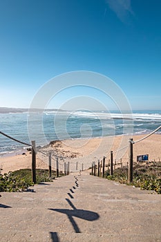 Wooden steps leading to Praia do Farol near Vila Nova de Milfontes in the Odemira region, western Portugal. Wandering along the photo