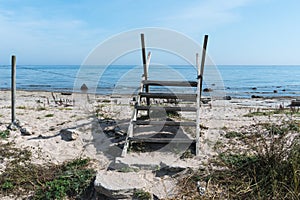 Wooden stile across a fence by the coast in summertime