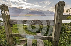 Wooden stile allowing access the a coastal walking path in Wales