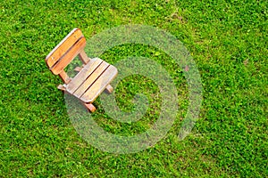 Wooden stool on green grass field