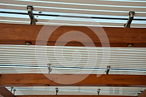 Wooden structure of the bus stop, the shelter of the gazebo pergola. the roof and walls are lined with glass. the glass is anchore