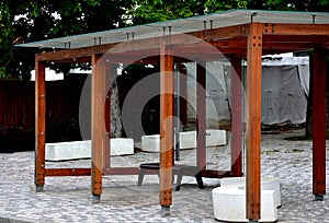 Wooden structure of the bus stop, the shelter of the gazebo pergola. the roof and walls are lined with glass. the glass is anchore