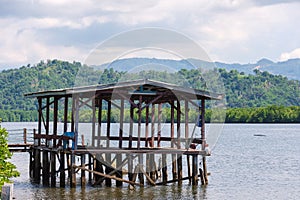 wooden structure with roof on a lake for anglers