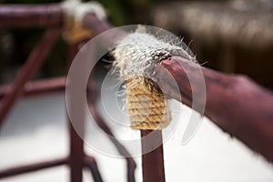 Wooden structure with a thick rope close-up