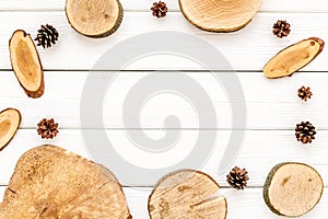 Wooden stumps and pine cones frame for blog background top view space for text