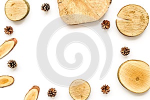Wooden stumps and pine cones frame for blog background top view space for text