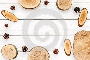 Wooden stumps and pine cones frame for blog background top view space for text