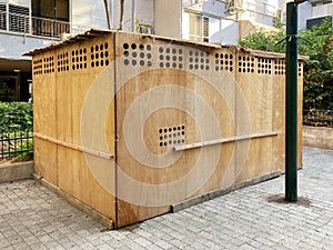 Wooden sukkah in a yard of a residential building in Israeli town during jewish holiday Sukkot