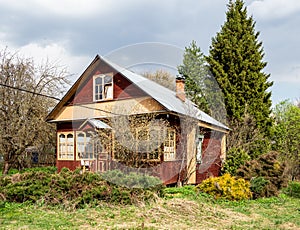 wooden summer house in village on overgrown yard