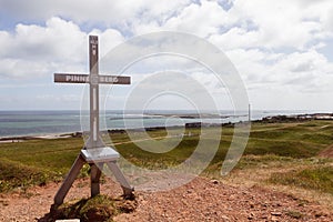 Wooden summit cross on the island of Heligoland in Germany under the cloudy sky