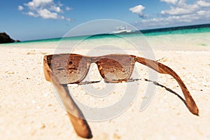 Wooden sunglasses on beach