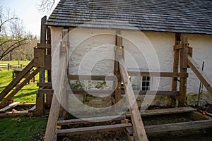 Wooden support scaffolding braces damaged colonial cottage