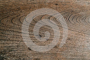 The wooden surface of an old board made of ash wood. The pattern is formed by the annual rings of ring-porous wood.