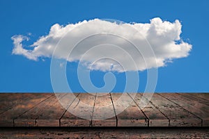 Wooden surface. Painted boards. Old table. Table surface. Wooden table against the background of a cloud on a blue sky