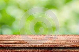 Wooden surface. Painted boards. Old table. Wooden table on natural green blurred background
