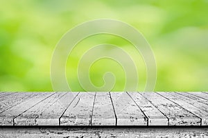 Wooden surface. Painted boards. Old worn table. Wooden table on natural green blurred background