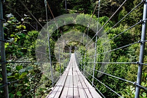 wooden suspension bridge in the forest beautiful mountain landscape