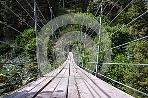 wooden suspension bridge in the forest beautiful mountain landscape