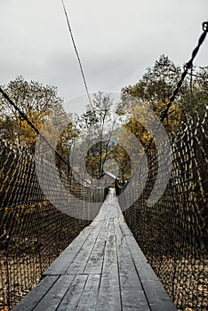 Wooden suspension bridge over a mountain river in a mountain village 2