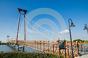 The wooden suspension bridge span that across the small lake at Wareepirom Park.