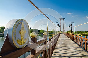 The wooden suspension bridge span that across the small lake at Wareepirom Park.