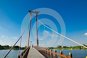 The wooden suspension bridge span that across the small lake at Wareepirom Park.