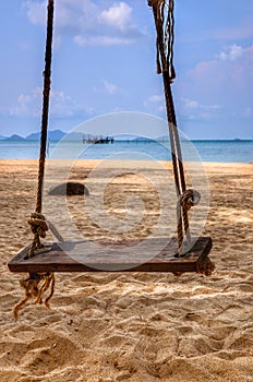 Wooden swing on the beach at koh mak , trat , thailand