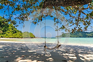 Wooden swing on beautiful white sand beach, Surin island national park, Phang nga, Thailand