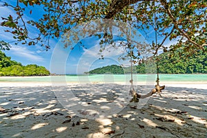Wooden swing on beautiful white sand beach, Surin island national park, Phang nga, Thailand