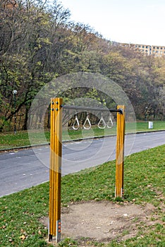 Wooden swing in city park near road