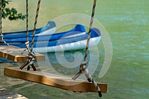 Wooden Swing and Conoe in Background