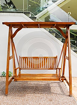 Wooden swing with double seat outdoors