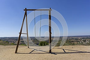 Wooden swing at Montemor-o-Novo, with a beautiful view of mountain, in Portugal