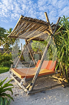 Wooden swing under a canopy on the tropical beach near sea, island Zanzibar, Tanzania, East Africa