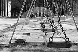 Wooden swings in park, space for text. Black and white effect