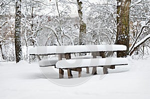 A wooden table in abandoned park on a winter evening