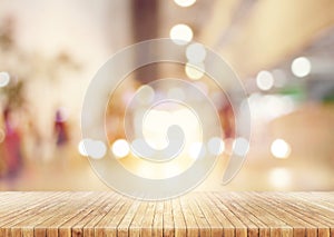 Wooden table in abstract blurred background of shopping mall