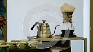 Wooden table adorned with white ceramic mugs and plates filled with freshly roasted coffee beans