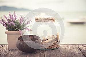 Wooden table at beach cafe with vintage style accessories in Provence style in pastel colors with sea view and copy space as hol