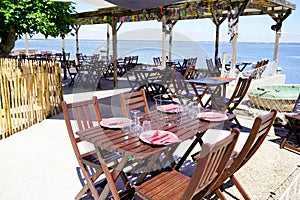 Wooden table on beach terrace for seafood oysters tasting on l`herbe village in Cap Ferret at bay Arcachon basin France