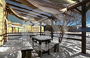 Wooden table and benches covered with snow