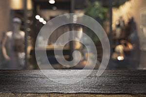 Wooden table with blur background of coffee shop.