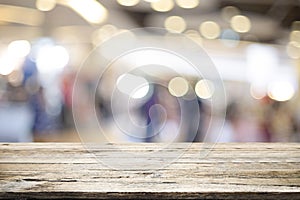 Wooden table with blur background of coffee shop.