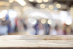 Wooden table with blur background of coffee shop.