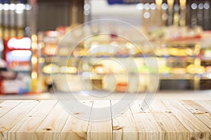 Wooden table with blur background of coffee shop.