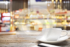 Wooden table with blur background of coffee shop.