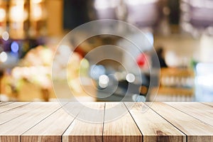 Wooden table with blur background of coffee shop